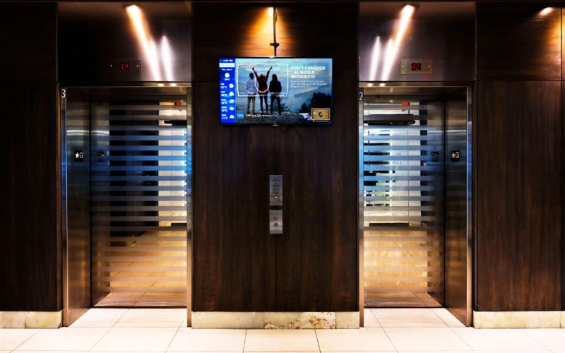 digital bulletin board between elevators